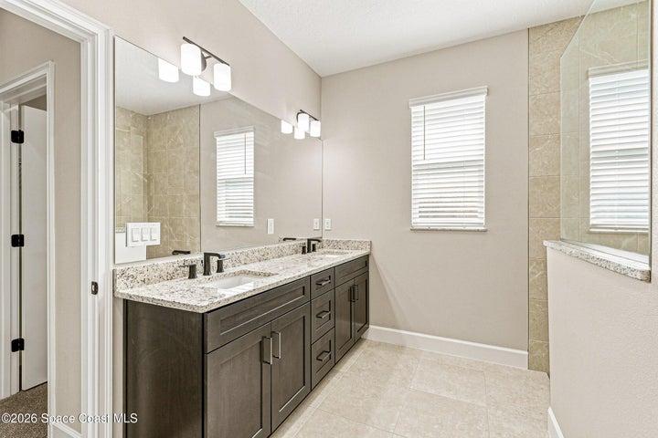 The primary bathroom offers granite countertops and dual sinks.