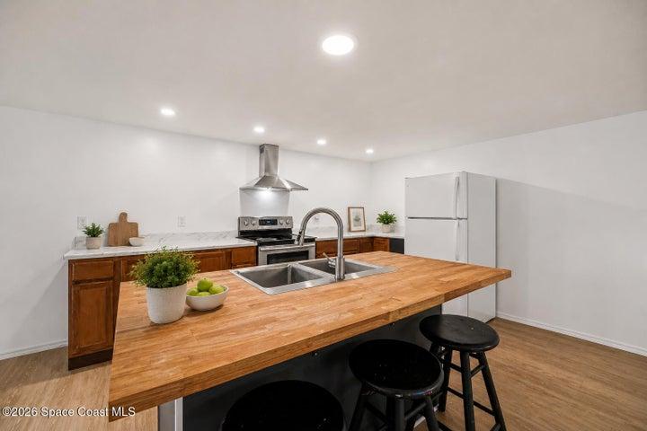 Updated Kitchen with Large Center Island, Stainless Hood, and Recessed Lighting