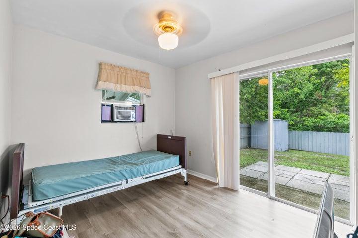 Bedroom with Sliding Doors Access to Fenced Backyard