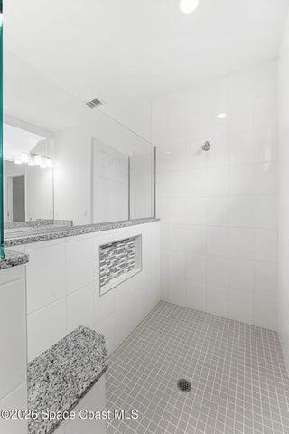 Oversized tiled walk in shower in the Primary bathroom.
