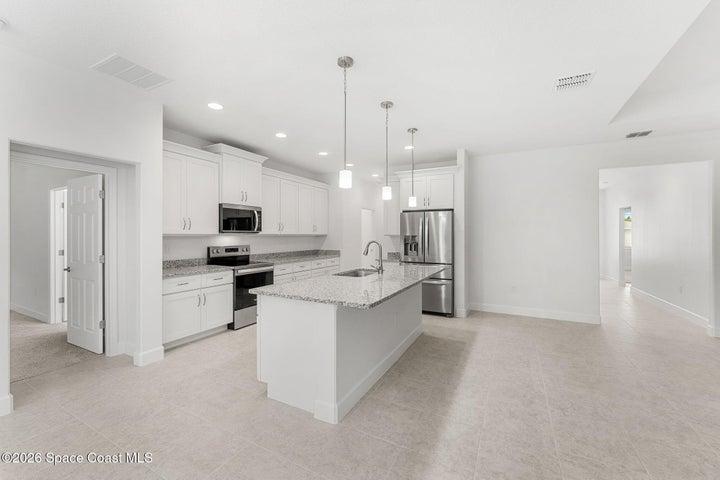 This upgraded home features Granite Countertops, stainless steel appliances, soft close cabinetry, crown molding, and a four door upgraded refrigerator.