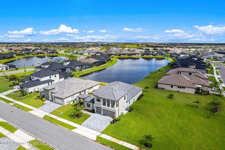 Aerial view showcasing the home with the scenic water nearby