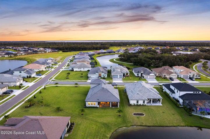 Bird’s-eye view highlighting the property and its beautiful waterside setting