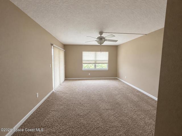 Loads of space in primary bedroom with accesss to screened porch (virtually unstaged)