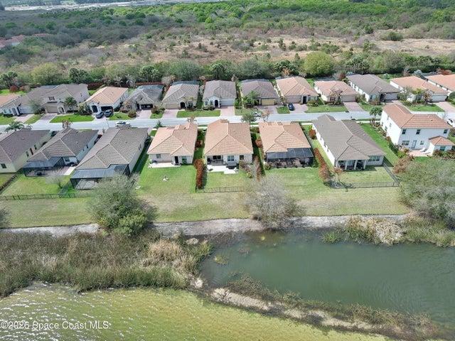 Aerial perspective showcasing three properties with tile roofs