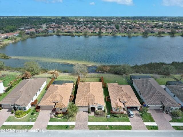 Aerial perspective showcasing three properties with tile roofs