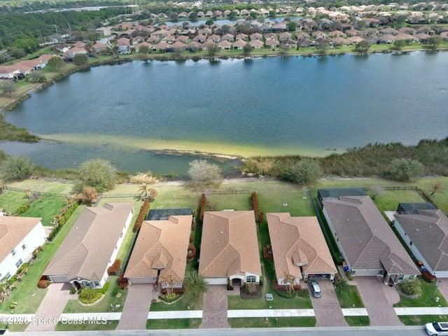 Aerial perspective showcasing three properties with tile roofs