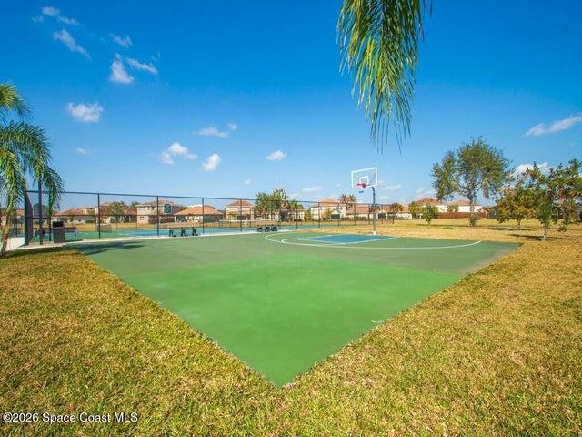 Multi-sport court featuring a basketball hoop and painted lines for various activities