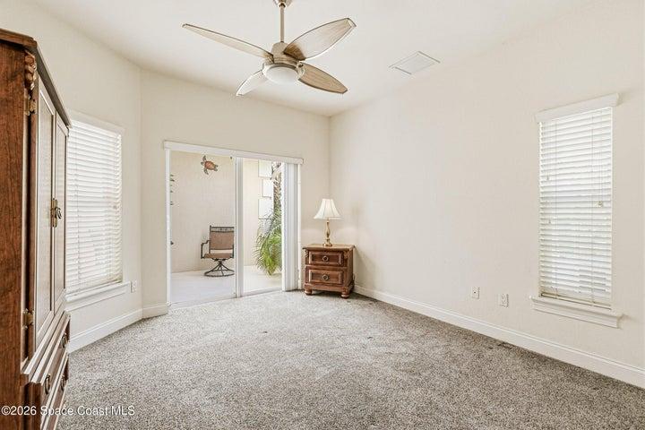 Secondary bedroom opens to front courtyard.