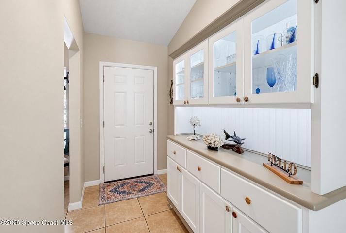 Built-in cabinetry with glass-front uppers and under-cabinet lighting