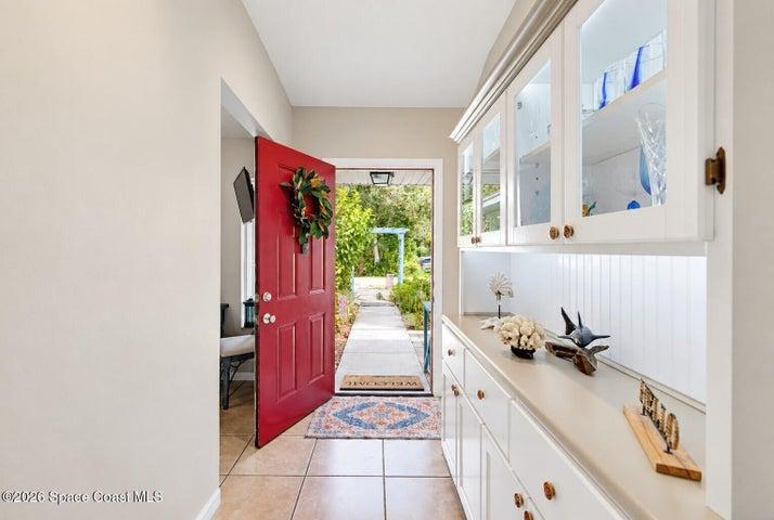Built-in cabinetry with glass-front upper doors, lower storage drawers, and a light-colored countertop