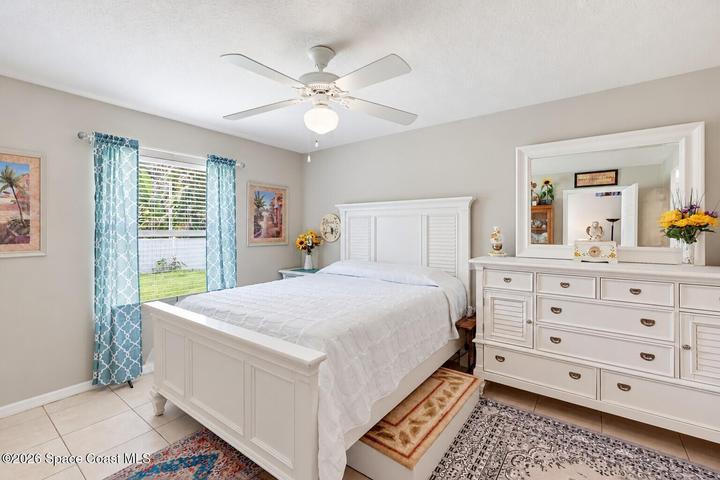 Ceiling fan with integrated lighting, window with horizontal blinds, tile flooring