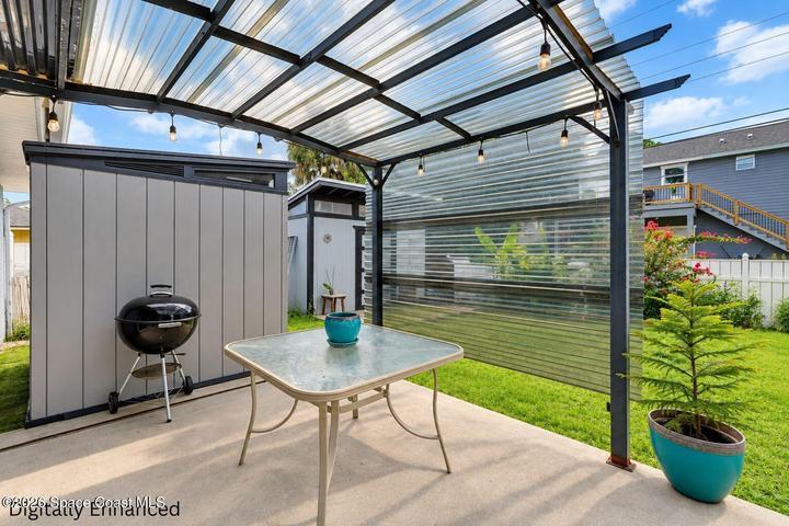 Covered patio with corrugated metal roof and string lighting