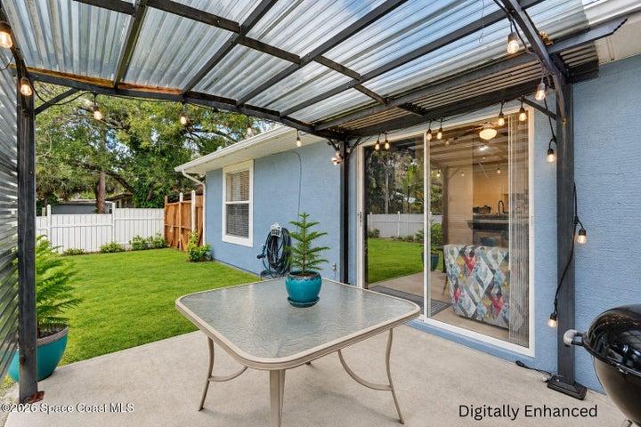 Covered patio with corrugated metal roof and string lighting