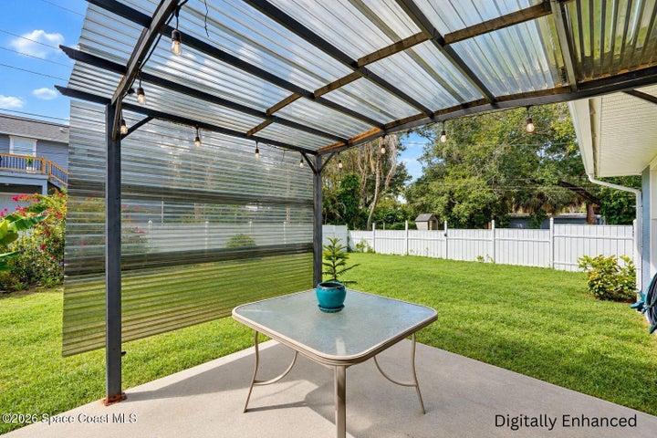 Covered patio with corrugated metal roof and string lighting