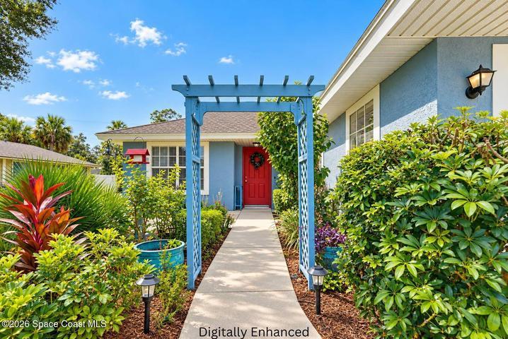 Vibrant blue exterior with a contrasting red entry door