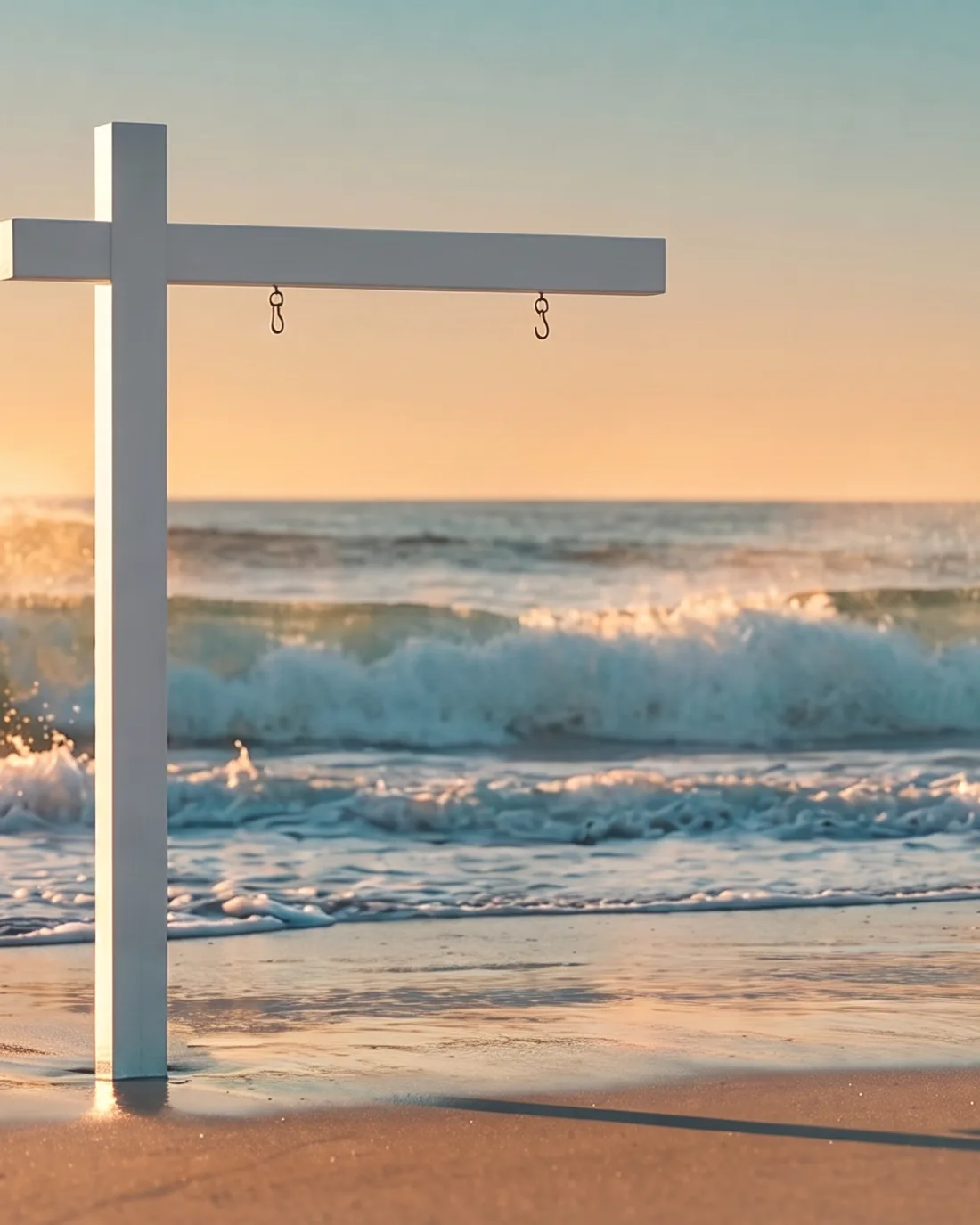 A 7 Waves Real Estate sign planted in the sand at sunset with waves rolling in behind it